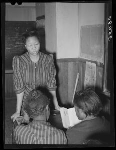Teachers and pupils gathered together in a segregated rural schoolroom in Creek County, Oklahoma.