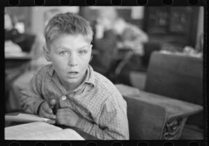 A student at a desk in a small rural schoolhouse in Williams County, North Dakota.